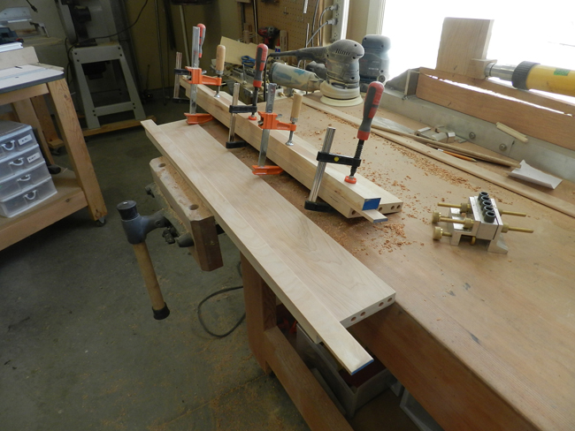 photo of trim work piece glued and clamped to lower edge of rail used to build the coffee table frame