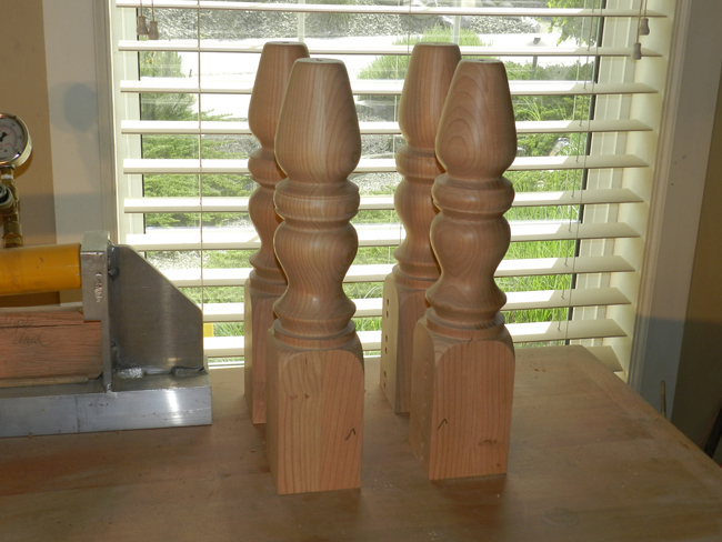 photo of turned legs used to build the coffee table frame with check marks to indicate placement of dowelmax device for drilling