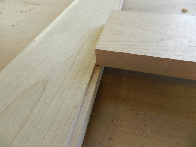 photo of checking the length of the glass support board used to build the coffee table top center section by inserting into glass recess in outer perimeter board