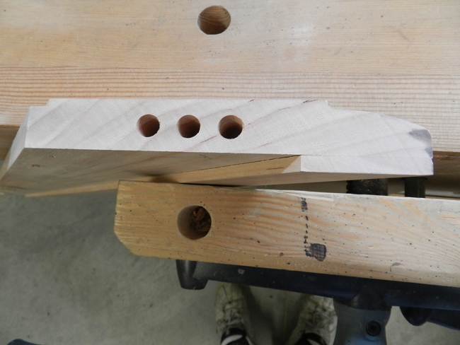 photo of dowel joint bores at end of mitered board used to build the coffee table top