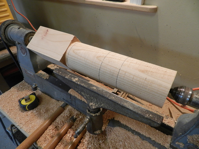 photo of 4 x 4 coffee table leg cylindrical section with scribe marks to locate sections of the turned design to be completed next