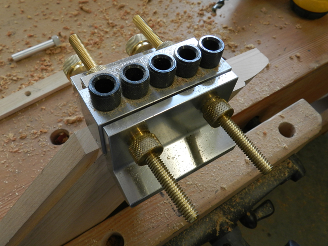 photo of Dowelmax device aligned on end of mitered rail to drill dowel joint bores used to build the coffee table top