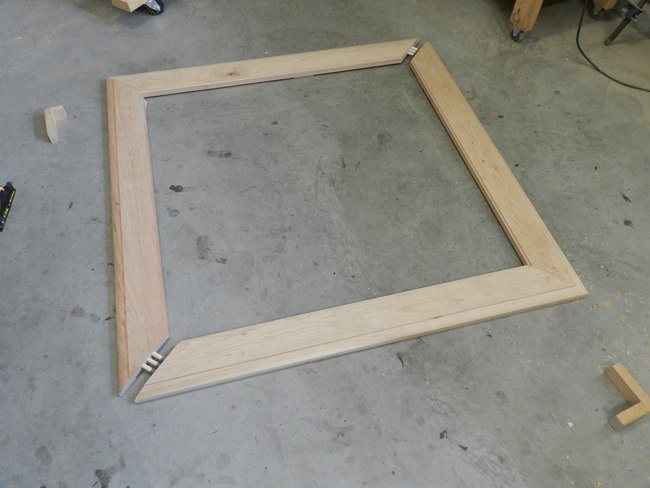 photo of mitered boards used to build the coffee table top joined in two L sections to accommodate dowels in two directions