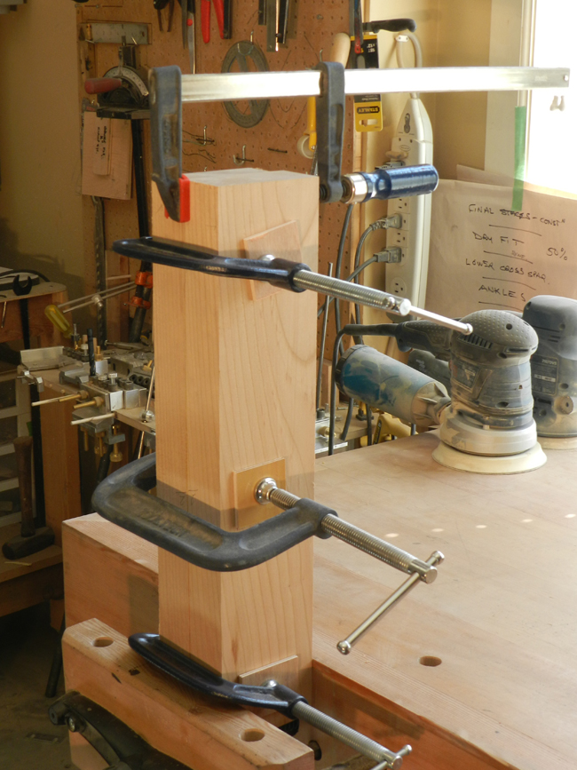 Coffee table leg work pieces glued and clamped face to face to create 4x4 leg.