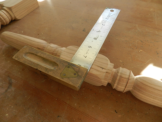 photo of marking a line with a set square to indicate the location of the lower rail on the leg work piece used to build the stool frame assembly