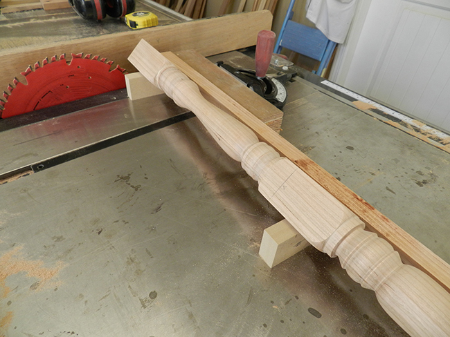 photo of stool leg positioned on two V blocks to cut six degree tapered cut at top to butt squarely and firmly with the underside of the stool seat