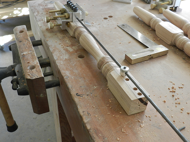 photo of Dowelmax device aligned with extended distance gauge to drill the lower rail to leg joint used to build the stool frame assembly