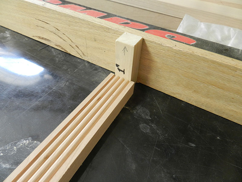 1-inch-spacer-used-to-adjust-table-saw-fence-for-cutting-bookcase-shelf-rails