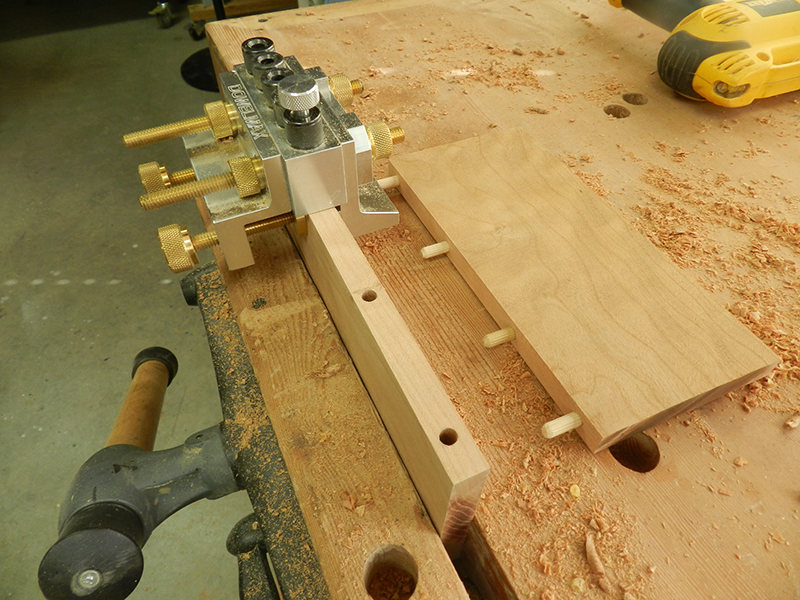 Dowelmax dowel jig with 1/8 spacer installed to center on half inch thick plant stand shelf.