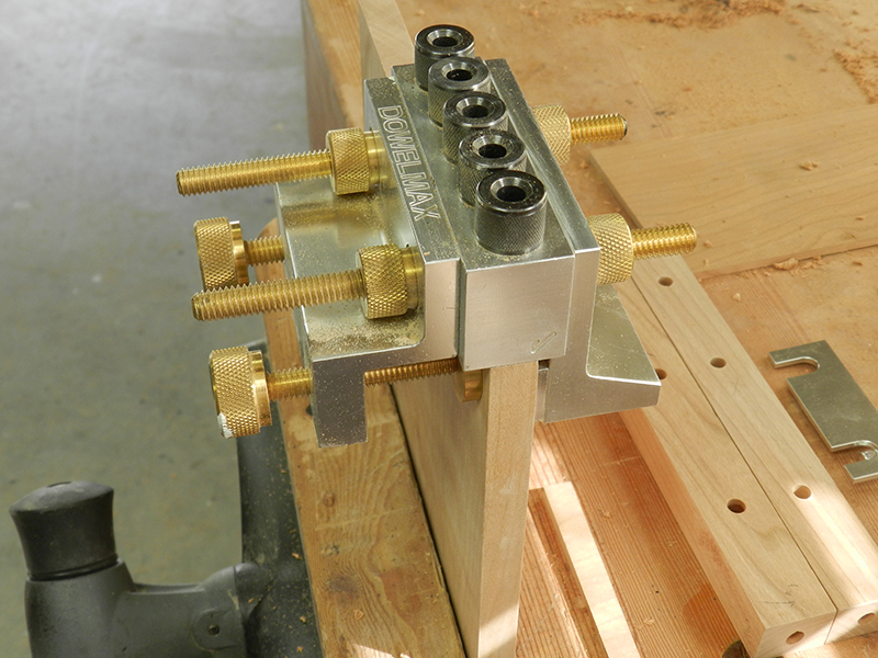 Dowelmax dowel jig with 1/8 spacer used to center on plant stand project 1/2 inch thick lower shelf work piece.