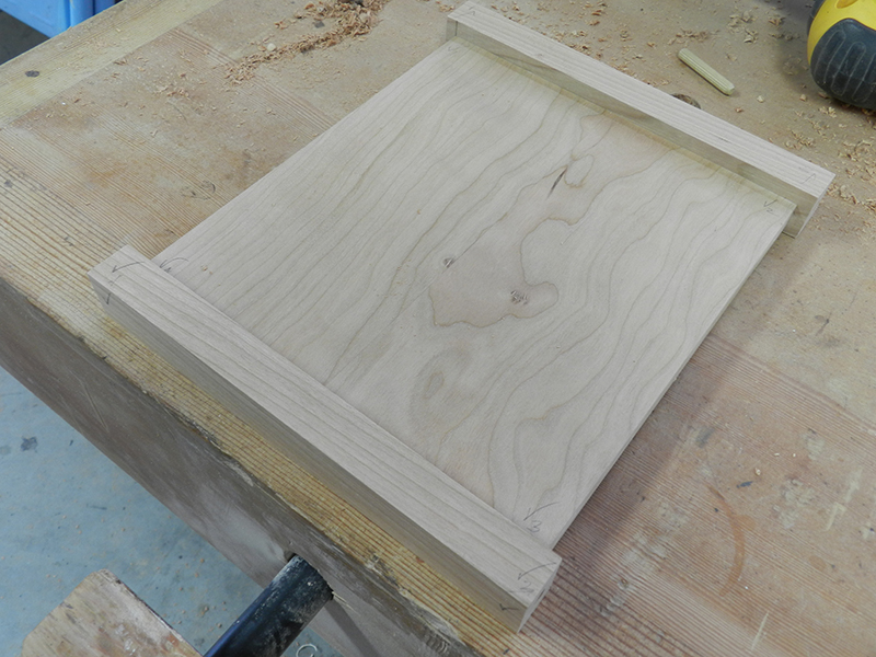 Plant stand project lower rails clamped to shelf to locate alignment marks for Dowelmax dowel jig.