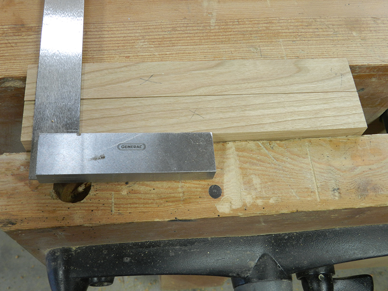 Using a set square to extend the alignment marks for the Dowelmax on the plant stand project lower rails.