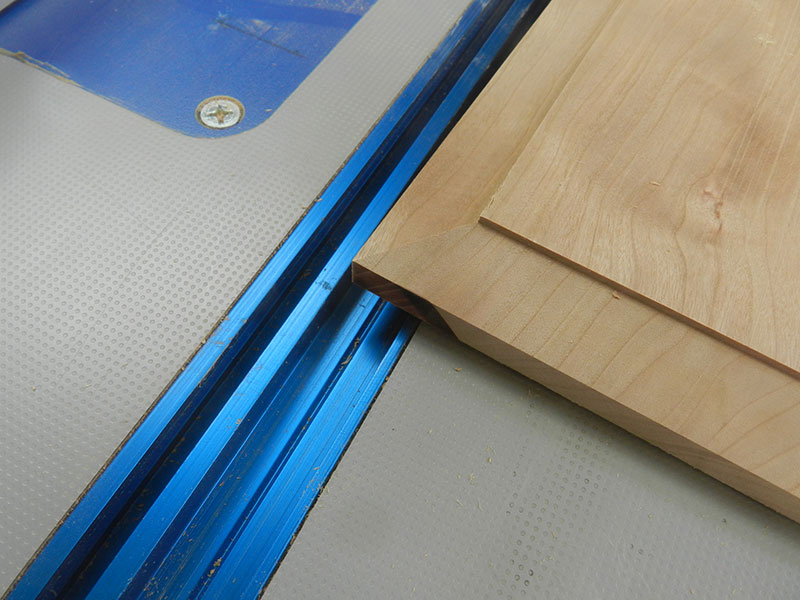 photo of bevel cut on router table into the main panel used to build the armoire drawer assembly front fascia
