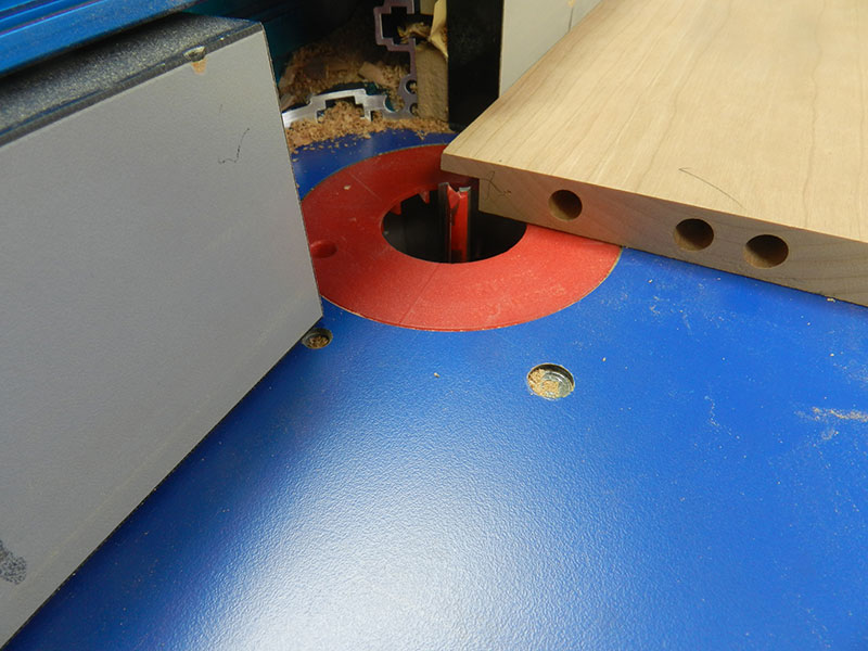 photo of dado recess cut on router table into work piece used to build the armoire drawer assembly walls. The recess will conceal the laminations on the lower panel made from plywood