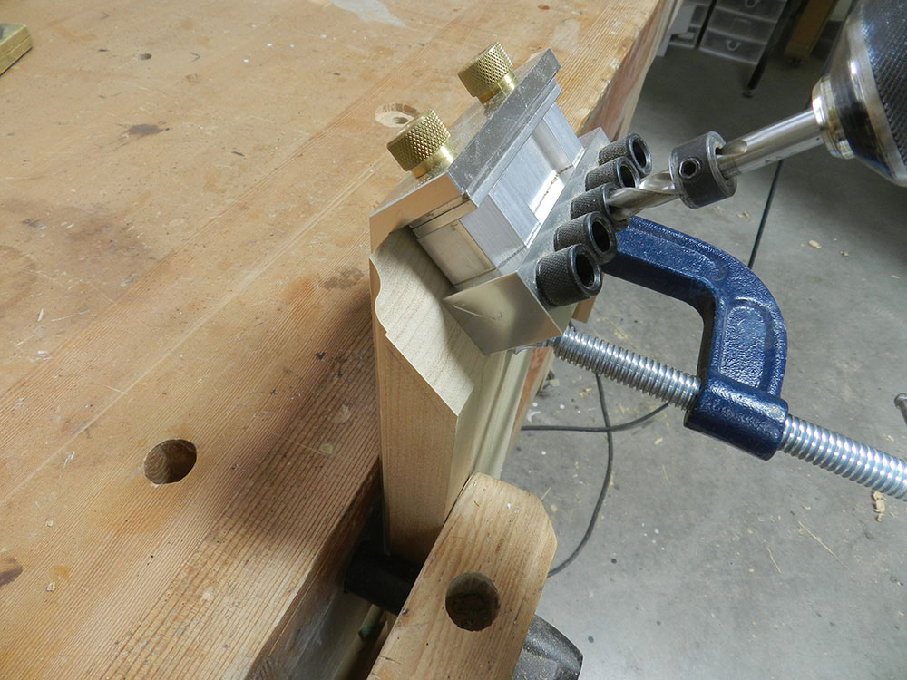 photo of Dowelmax miter accessory aligned and clamped to work pieces to drill dowel bores used to build the armoire chippendale feet