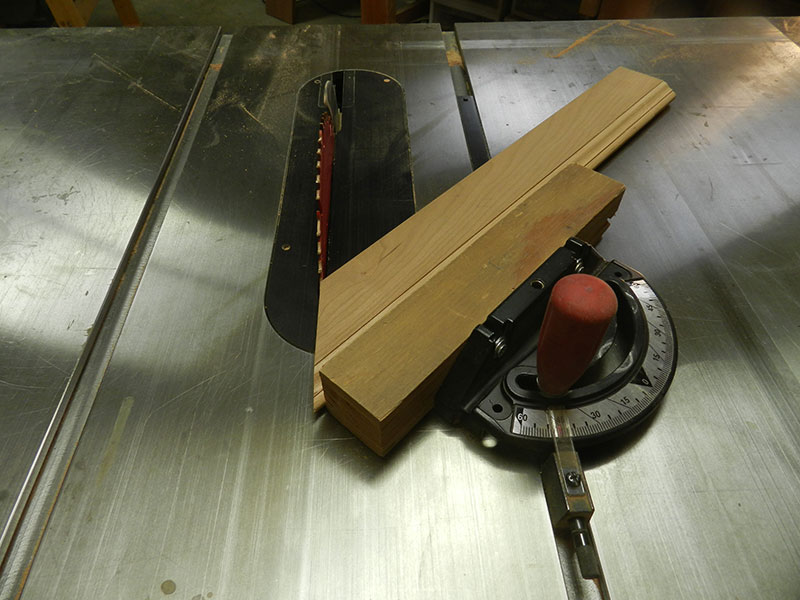 photo of mitered rail used to build the armoire top plate side perimeter section shown cut on table saw with miter guide