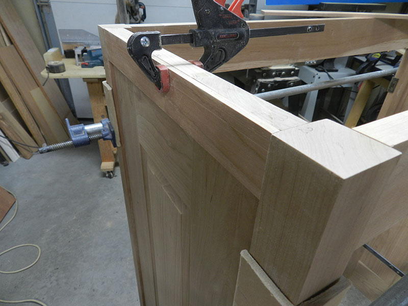 photo of filler work piece for attachment of moulding installed into relief between panel assembly and corner posts used to build the armoire frame side section