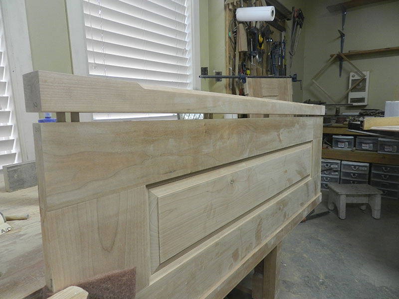 photo of multiple dowel joint between the raised panel assembly and corner post used to build the armoire frame side section partially closed to show detail