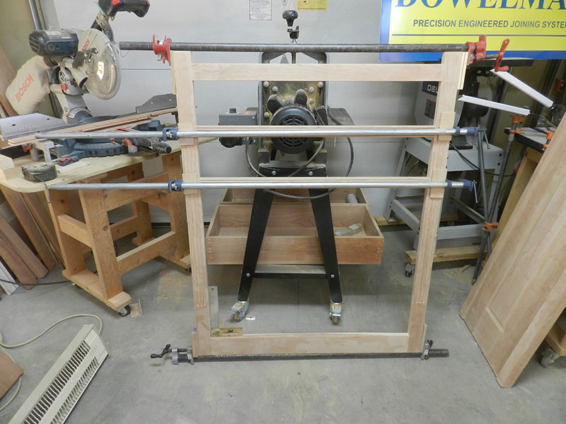 photo of rails and stiles used to build the amoire frame assembly front section shown glued and clamped together