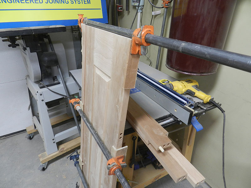 photo of raised panel assembly and one of the corner posts used to build the armoire frame assembly side section shown glued and clamped together