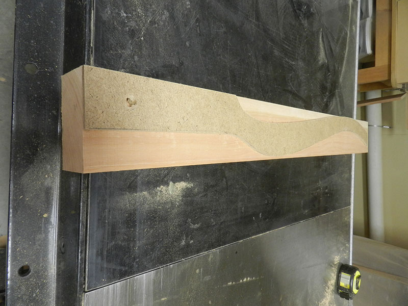 photo of the template made from hardboard for marking the cabriole shape on the work piece used to build the bedside table leg