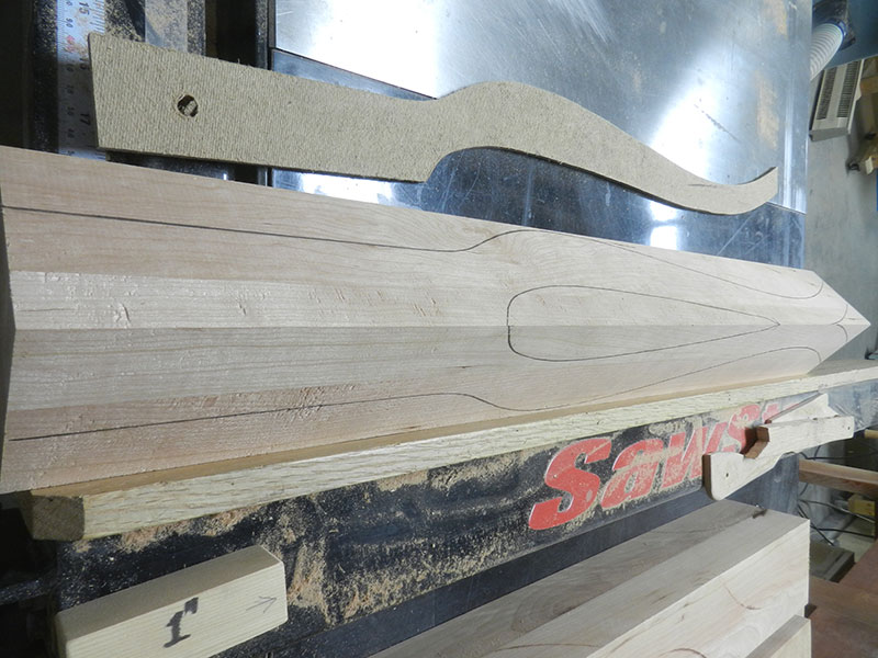 photo of two cherry work pieces joined together to build the bedside table leg blank with cabriole shape outline formed using template