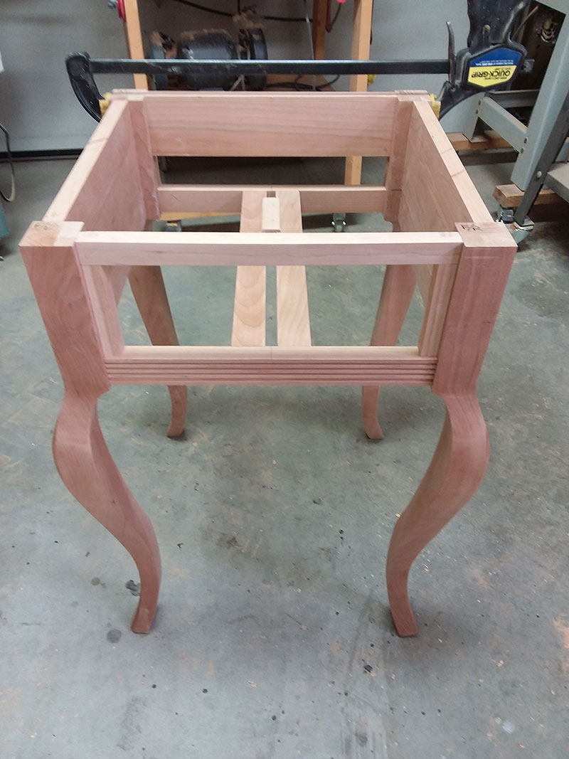 photo of the two drawer guides and one drawer slide (shown inverted) used to build the bedside table frame drawer section