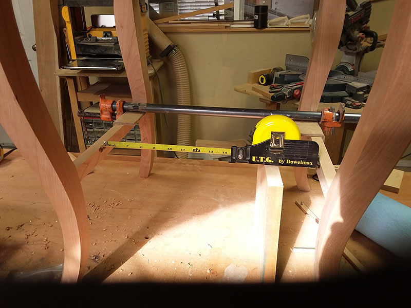 photo of method of measuring the precise length of the shelf used to build bedside table frame lower section with the UTG tape measure gauge