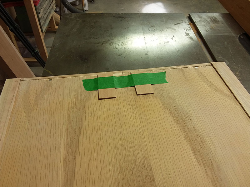 photo of risers used at rear of bedside table drawer bottom to prevent angular misalignment with respect to the drawer fascia panel